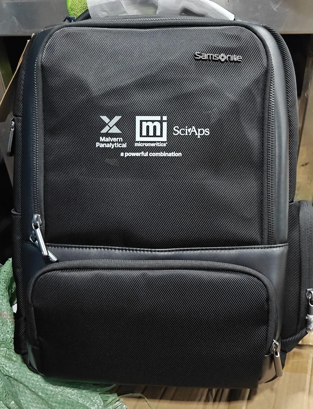 Black Samsonite backpack printed with co-branded corporate logos