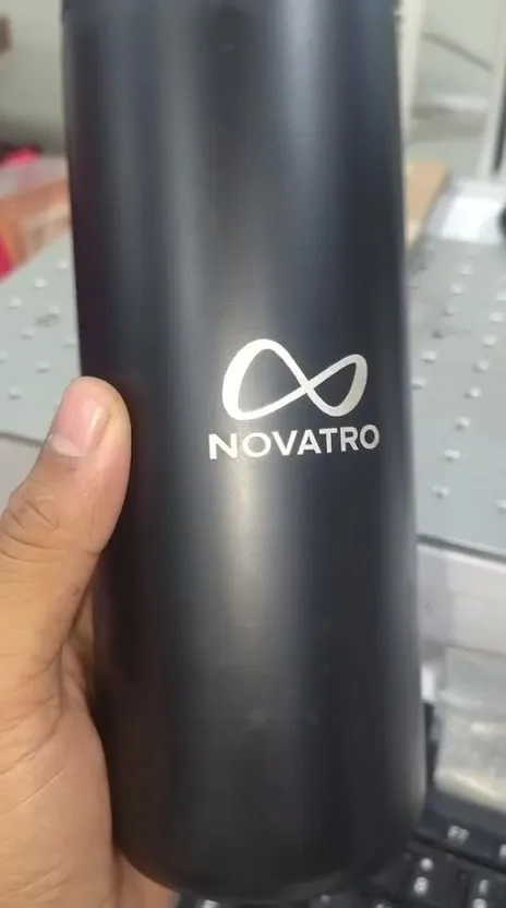 Laser-marked black metal bottle